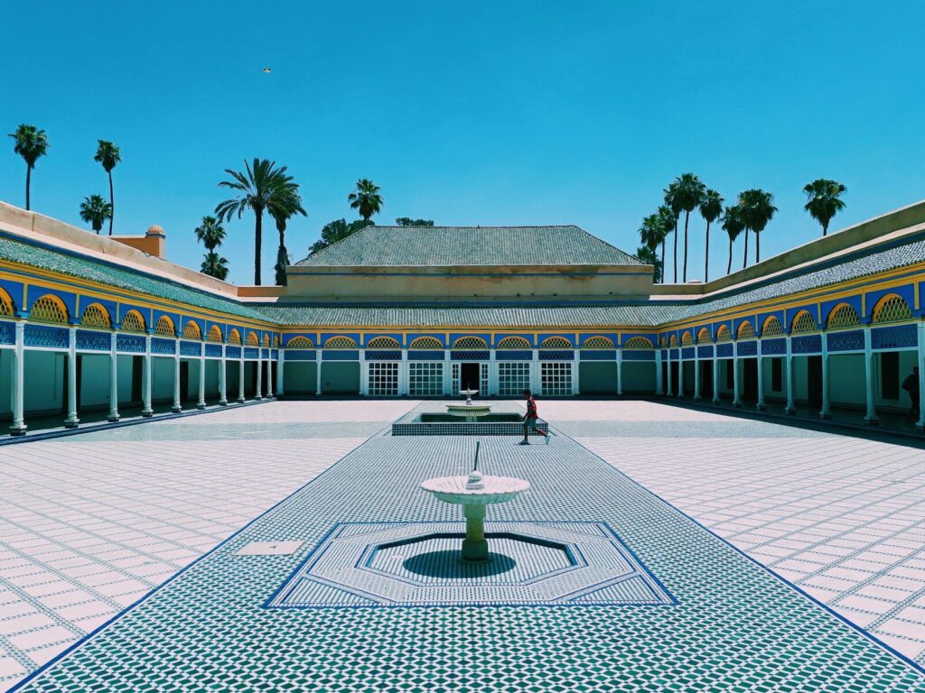 person walking near Marrakech building during daytime